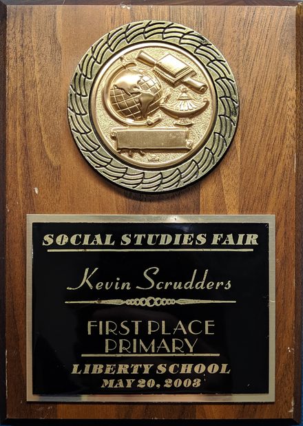 Kevin Scrudders with his first-place social studies fair project
