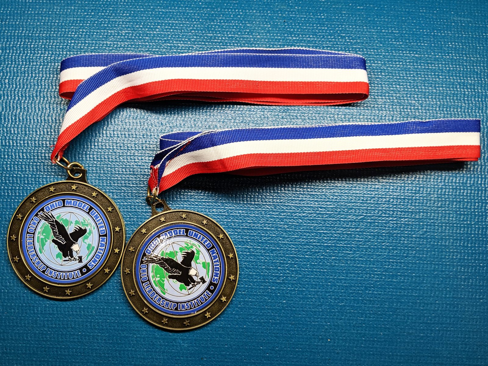 Two Ohio Model United Nations medals on red, white, and blue ribbons