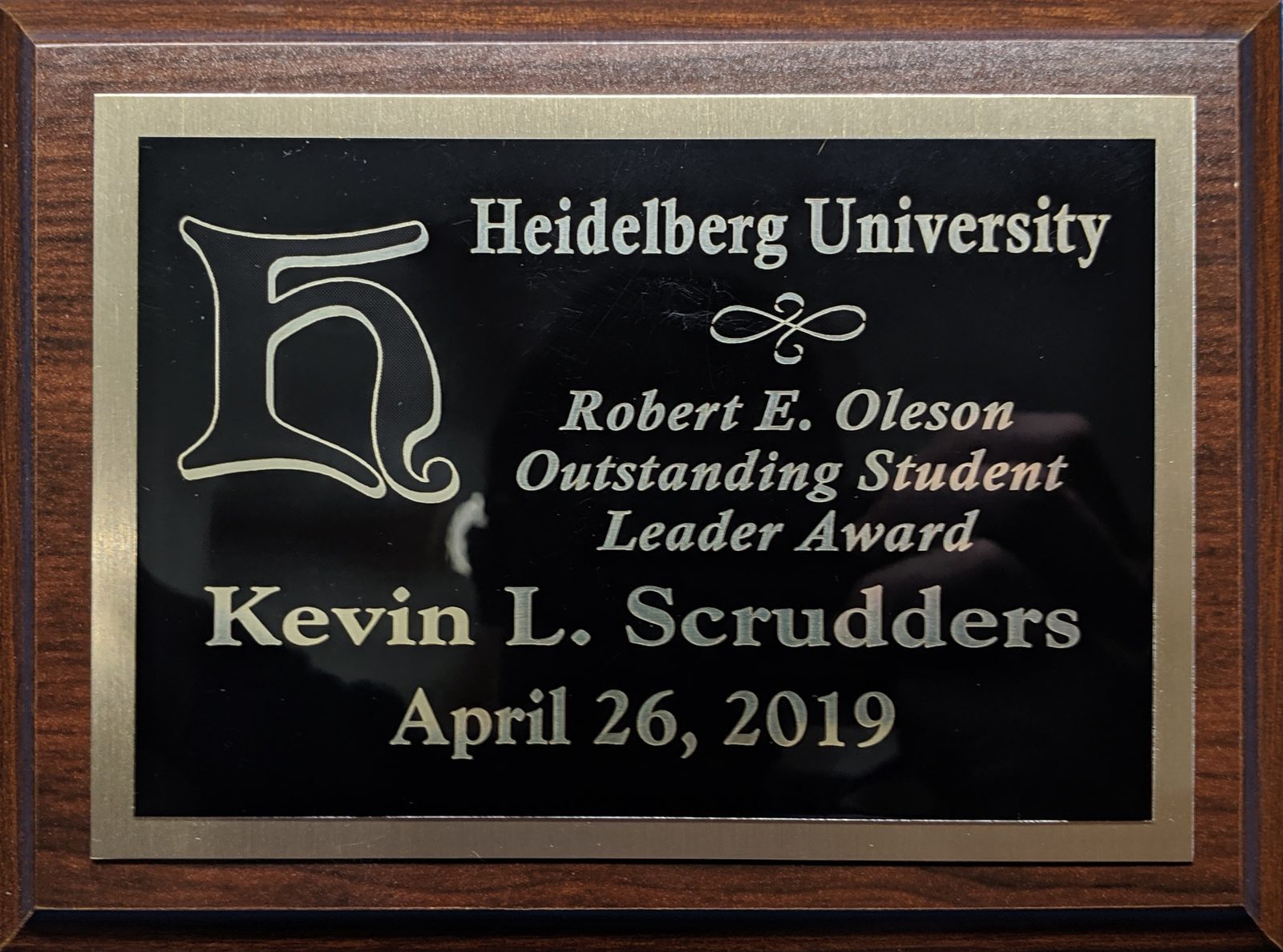 Kevin Scrudders receiving the Robert E. Oleson Outstanding Student Leader Award